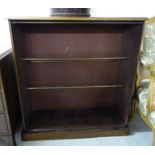 A late Victorian mahogany shoe cabinet with an open front, enclosing four brass rails,