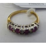 A 9ct gold claw set ruby and diamond half-eternity ring 11