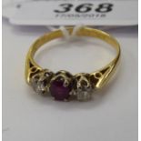An 18ct gold ring, claw set with a central ruby,
