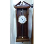 A modern TW Bazeley gravity clock; the movement faced by a Roman dial,
