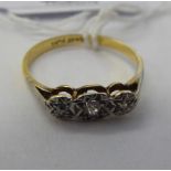 An 18ct gold and platinum three stone diamond ring 11