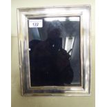A glazed, cushion moulded silver photograph frame,