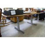 A modern rosewood refectory table, the top with rounded corners,