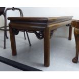 A modern Chinese fruitwood coffee table, the top with a mitred edge,