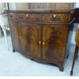 A modern Regency style mahogany bow front sideboard with three drawers and two doors,