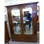 A late Victorian satinwood inlaid mahogany wardrobe with two mirrored doors and two drawers,