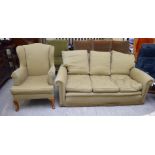 A modern two person settee upholstered in diamond patterned, old gold coloured fabric,