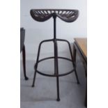 A cast and patinated iron bar stool, fashioned as a tractor seat,