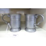 A pair of Victorian half-pint size pewter tankards with banded decoration,