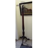 A 1930s mahogany standard lamp with a reeded column and a tripod base 64''h overall CA