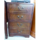 A modern mahogany pedestal filing cabinet, the top with a tooled green hide scriber,