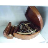 A modern brass sextant, in a fruitwood case; and a modern brass four section telescope,