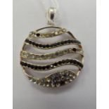 A white metal disc design pendant,