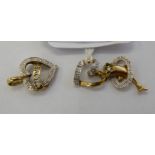 Three diamond set, gold coloured metal pendants, one featuring a dolphin, the others,