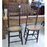 A pair of Edwardian stained beech framed, bamboo effect, ladderback child's correction chairs,