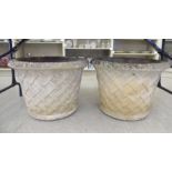 A pair of composition stone garden planters with basketweave decoration 18''h 24''dia SL