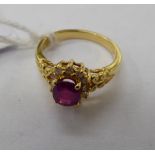 An 18ct gold claw set ruby and diamond cluster ring 11