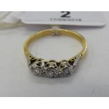 An 18ct gold three stone diamond ring 11