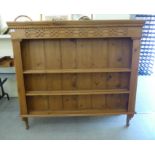 A modern waxed pine plate rack with a moulded cornice and three open front shelves 52''h 56''w