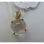 A 9ct gold claw set moonstone and diamond pendant 11