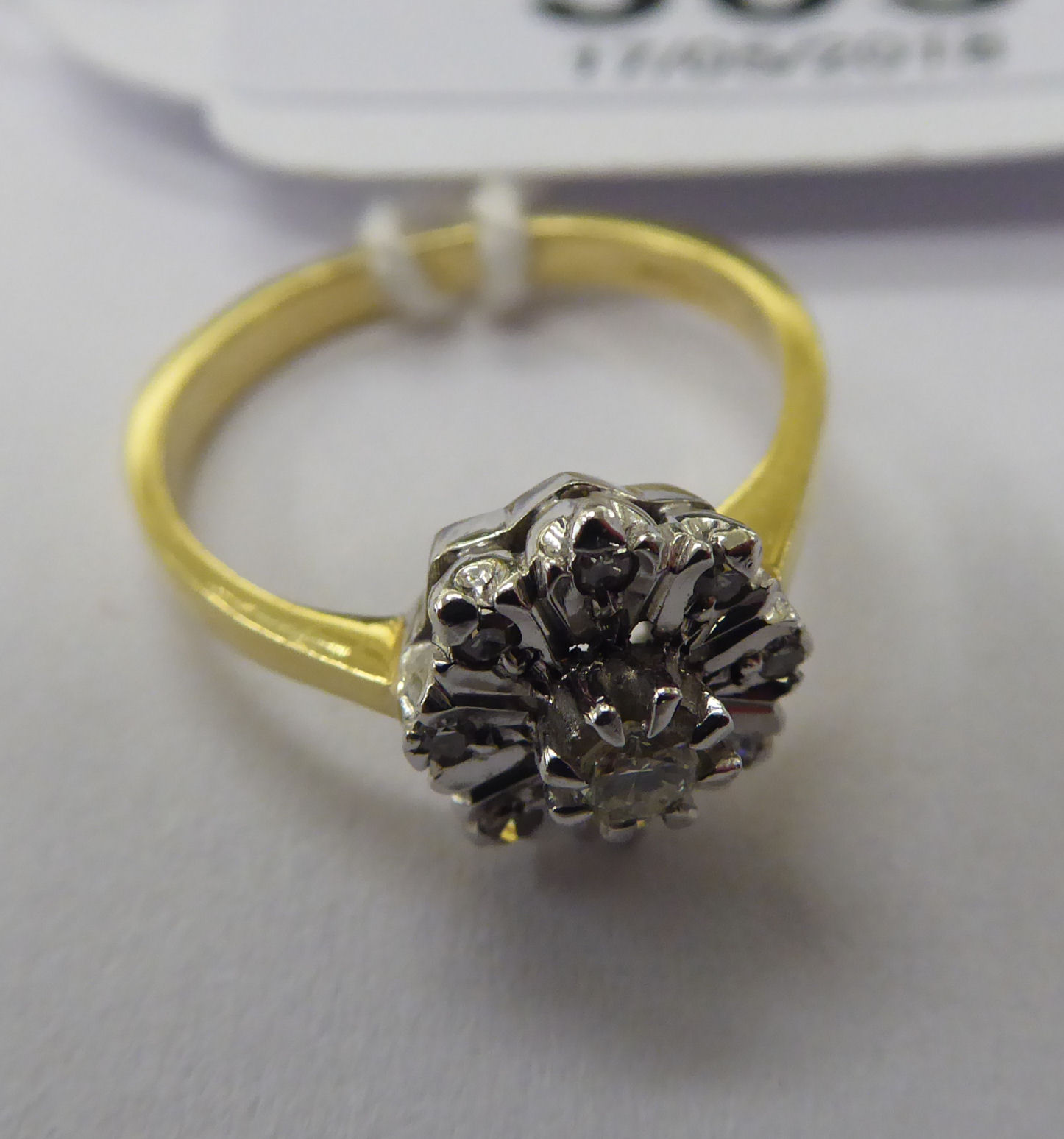 An 18ct gold diamond cluster ring 11