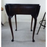 A mid 20thC mahogany drop leaf occasional table with a single drawer,