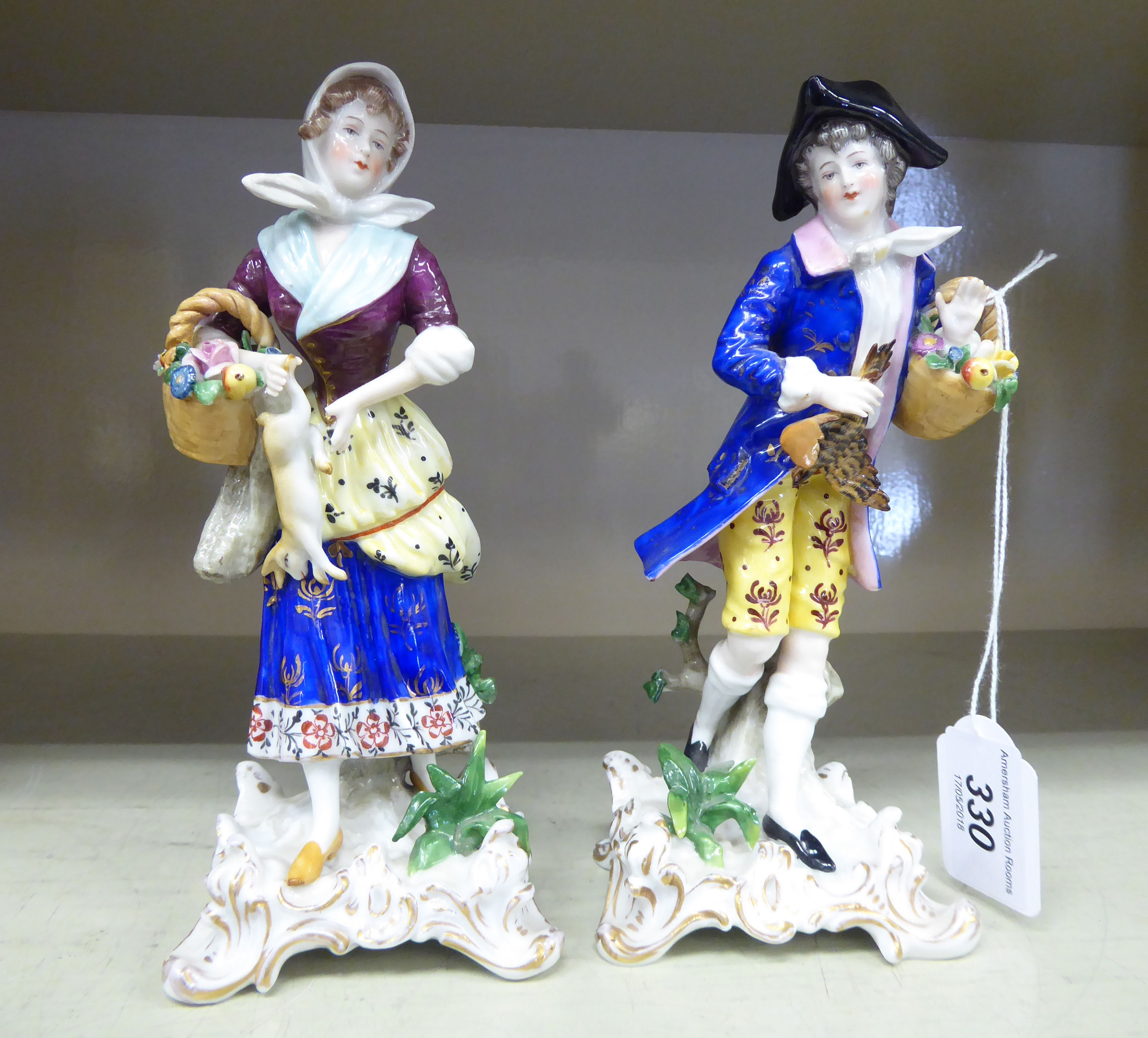 A pair of early 20thC Continental porcelain figures,
