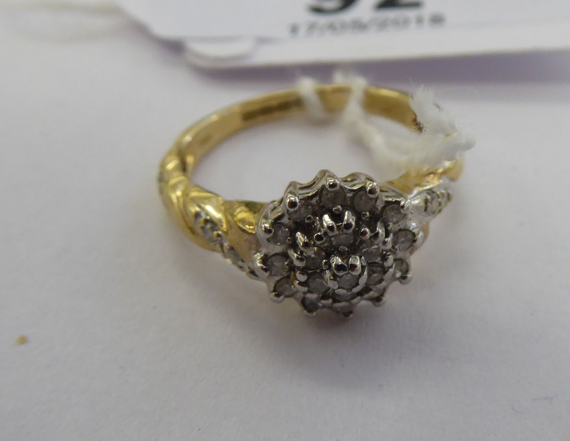 A 9ct gold claw set diamond cluster ring 11