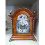 A modern burr walnut cased mantel clock;