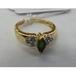 A 14ct gold ring with a central emerald,