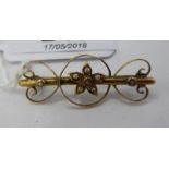 An 'antique' gold coloured metal brooch with floral, heart shaped and C-scrolled ornament,