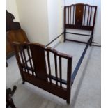 An Edwardian ebony and string inlaid mahogany single bed head and foot,