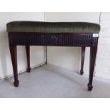 An Edwardian mahogany framed duet piano stool with an upholstered hinged box seat, raised on square,