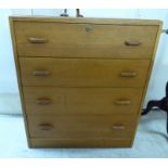 A 1950s light oak four drawer dressing chest,