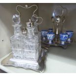 Two early 20thC silver plated cruet stands, one fitted with glass bottles,