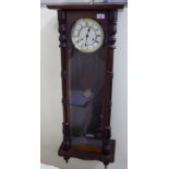 An early 20thC glazed mahogany cased Vienna wall clock with turned pilasters and drop finials;