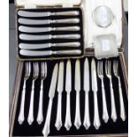 Two similar silver compacts; a set of six loaded silver handled butter knives;