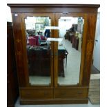 A late Victorian satinwood inlaid mahogany wardrobe with two mirrored doors and two drawers,