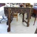 A mid 20thC Chinese hardwood hall table,