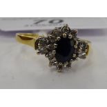 An 18ct gold claw set sapphire and diamond cluster ring 11