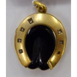A late Victorian pendant locket, fashioned as a horseshoe,