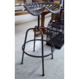 A cast and patinated iron bar stool, fashioned as a tractor seat,