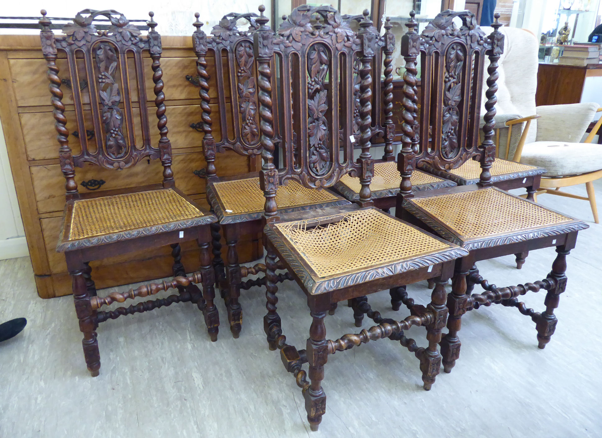 A set of six early 20thC Jacobean style carved oak framed dining chairs,