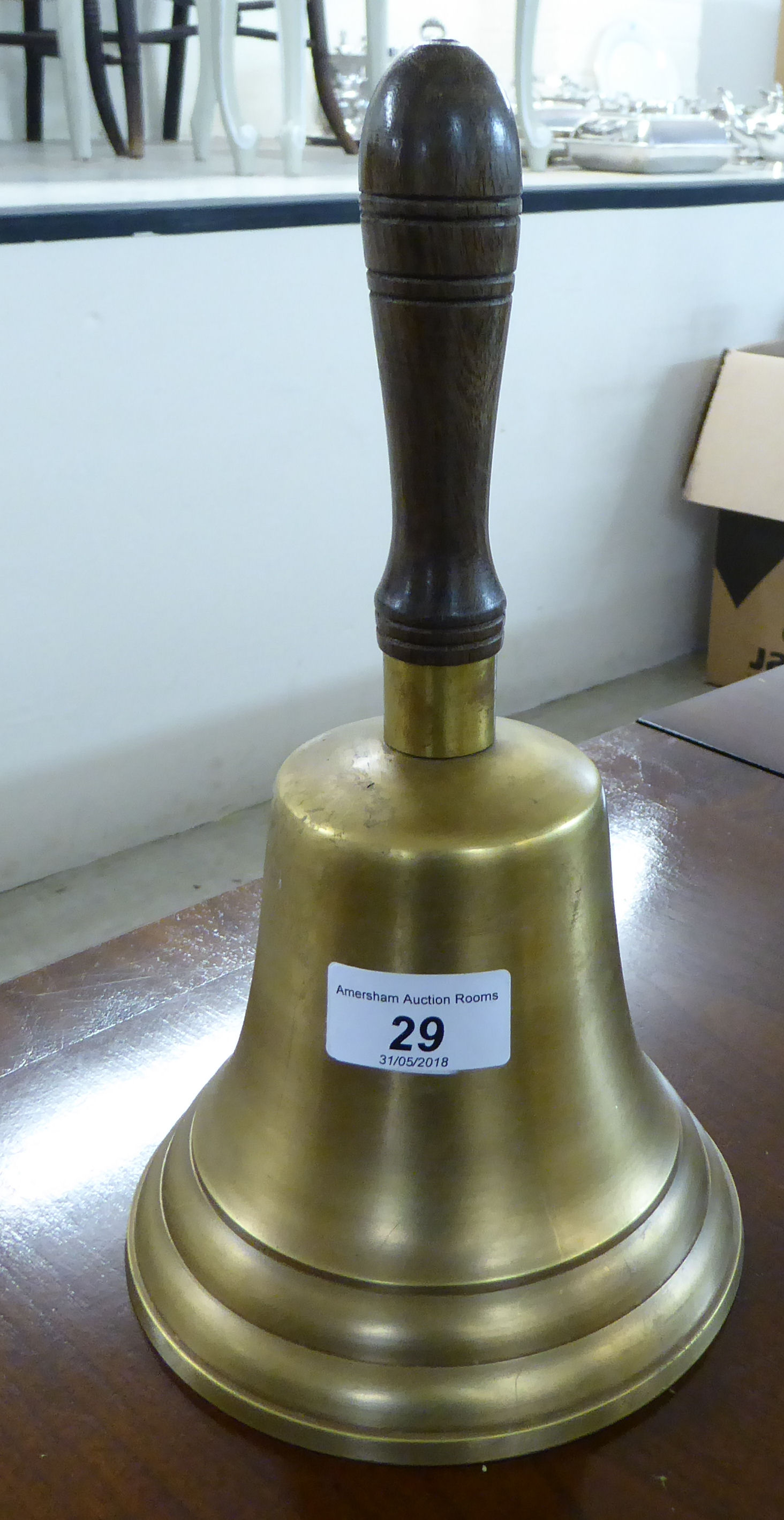 A reproduction of an early 20thC brass school bell OS4