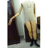 An early 20thC part painted moulded plaster and carved wooden mannequin (no head) the torso