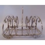 A William IV silver toastrack with six scrolled wire divisions and a central,