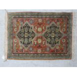 A part silk and woollen rug with two star design motifs,