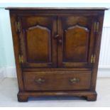 A Titchmarsh & Goodwin Old English style oak television cabinet, fashioned as a cupboard,