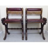 A pair of early 19thC foliate carved, oak framed hall chairs, each with a low level bar back,