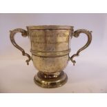 An Edwardian silver trophy cup with double C-scrolled handles,